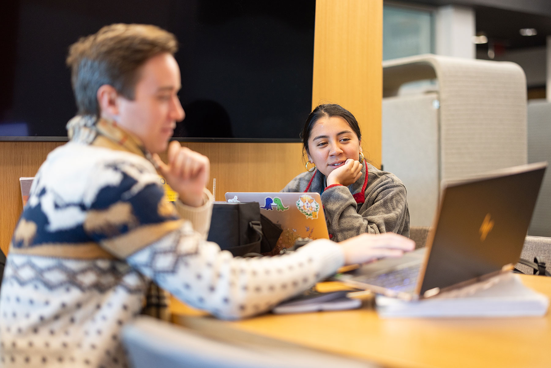 One person showing the other person information on laptop computer